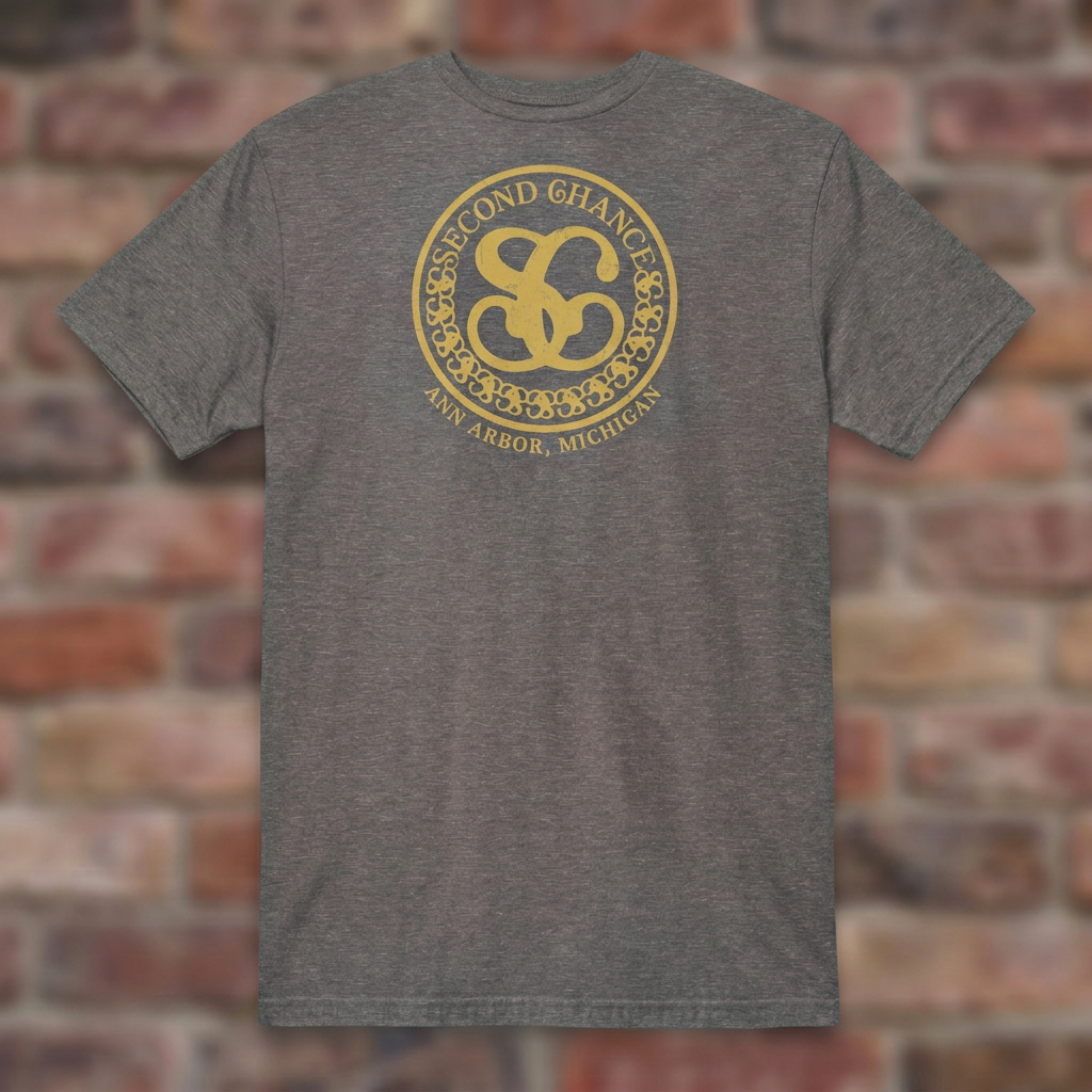Second Chance Graphite Heather T-shirt flat lay on brick background