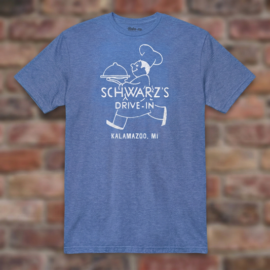 Schwarz's Drive-In Heather Royal T-shirt flat lay on brick background
