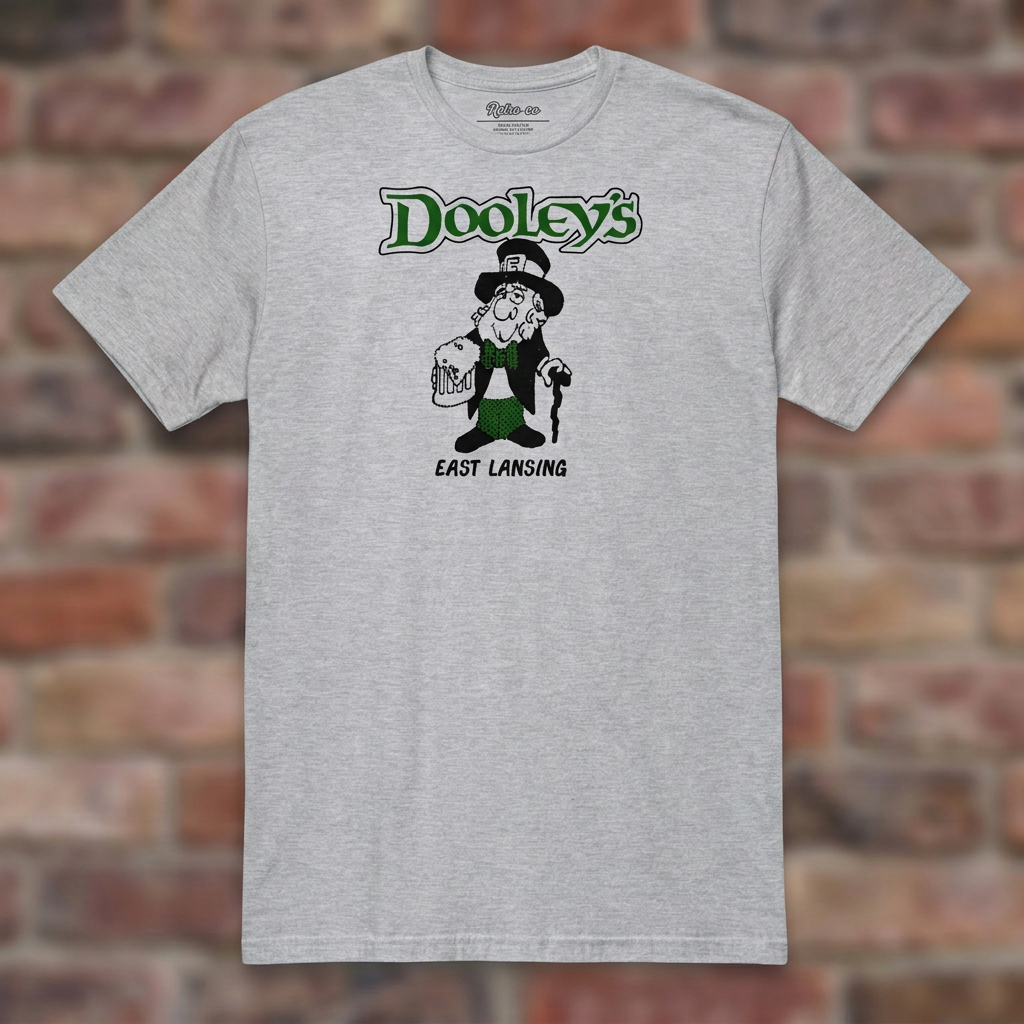 Sport Grey Dooley's East Lansing T-shirt flat-lay against weathered brick