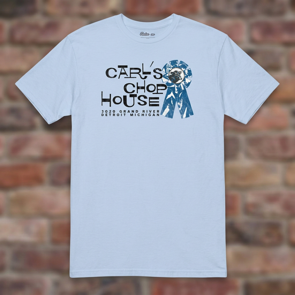 Carl's Chop House Light Blue T-shirt flat lay on brick background