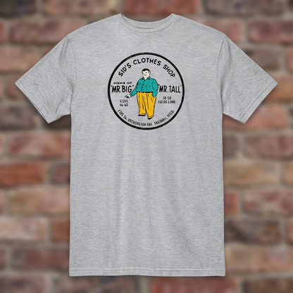 Sid's Clothing Shop Saginaw T-shirt in Sport Grey, flat lay on warm brick background