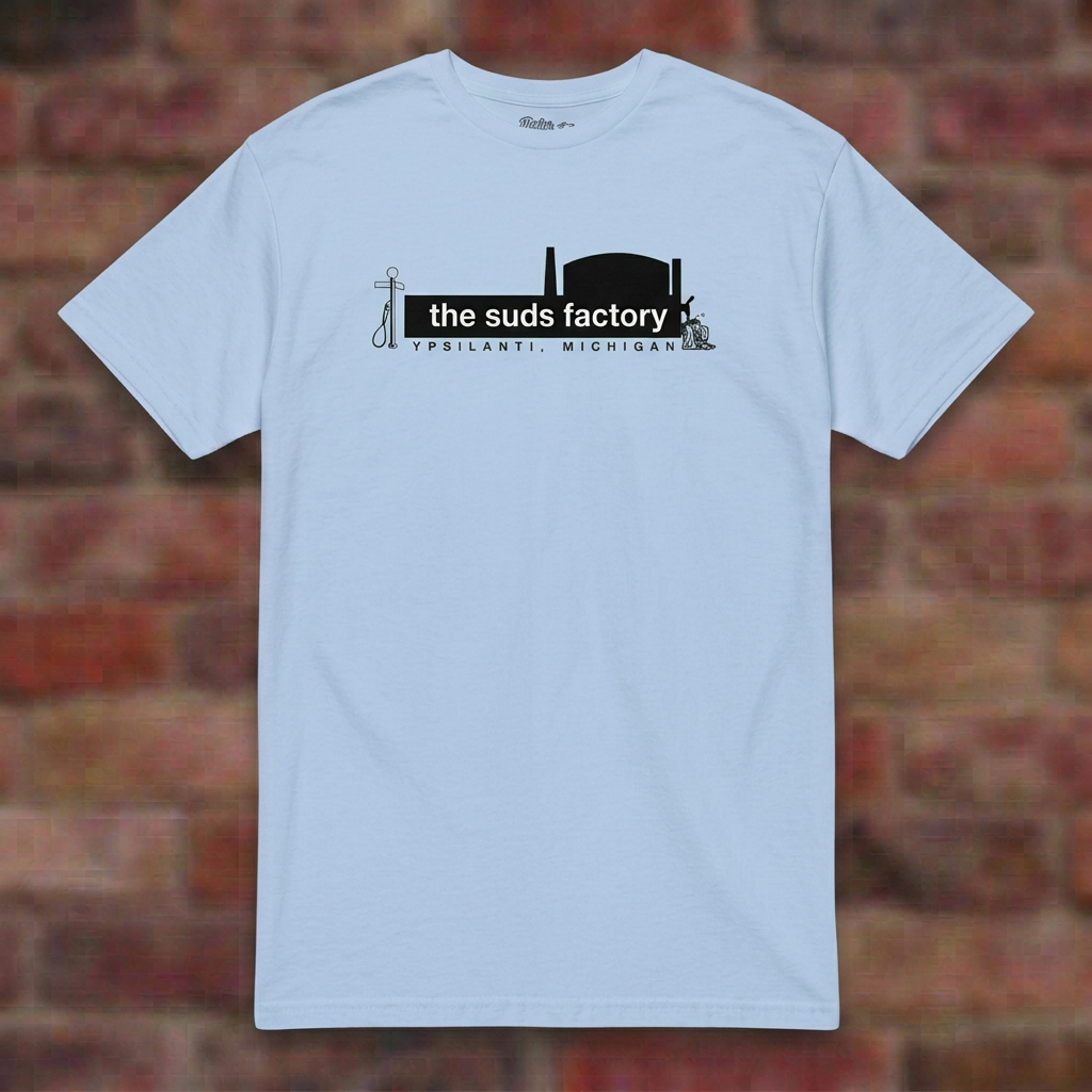 The Suds Factory Light Blue T-shirt flat lay on brick background