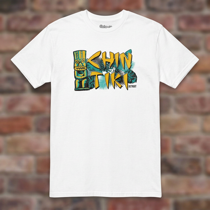 Chin Tiki White T-shirt flat lay on brick background