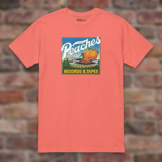 Peaches Records & Tapes Coral Silk T-shirt flat lay on brick background