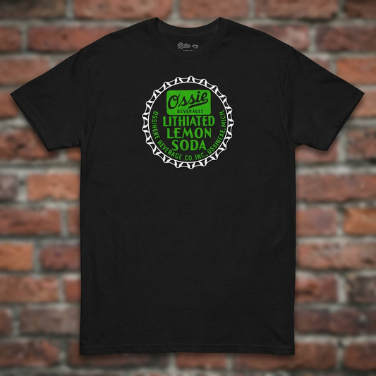 Ossie Beverages Black T-shirt flat lay on brick background