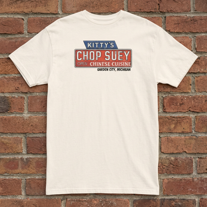 Kitty's Chop Suey Natural T-shirt flat lay on brick background