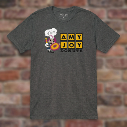 Amy Joy Donuts Graphite Heather T-shirt flat lay on brick background