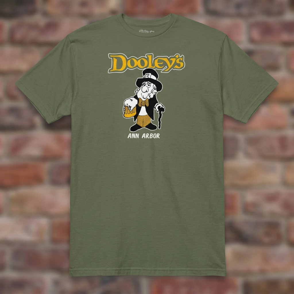 Dooley's Ann Arbor Military Green T-shirt flat lay on brick background