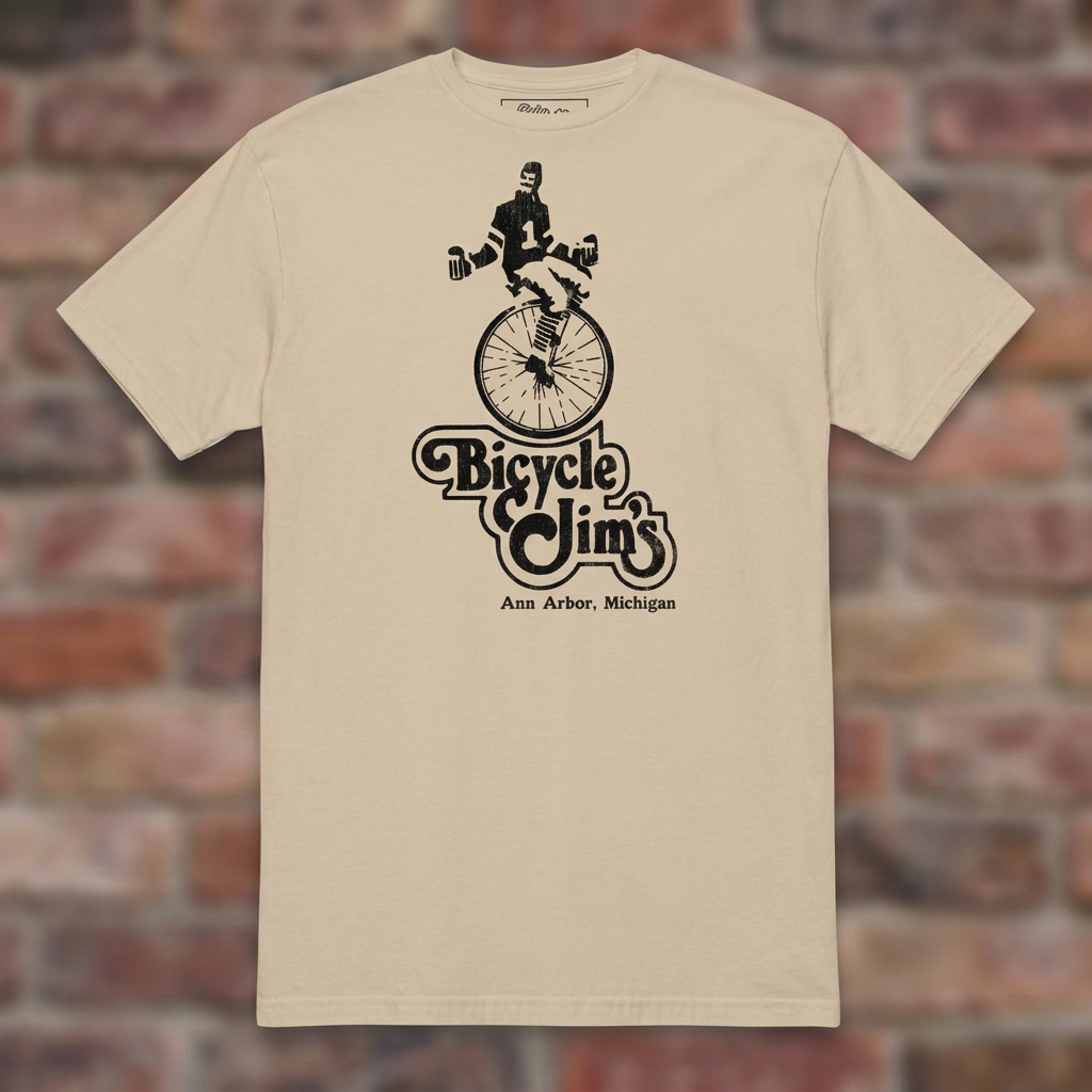 Bicycle Jim's Sand T-shirt flat lay on brick background