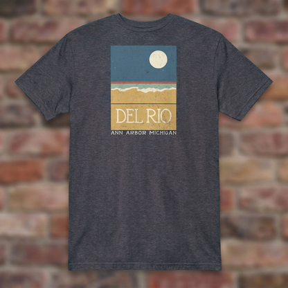Del Rio Ann Arbor Heather Navy T-shirt flat lay on brick background