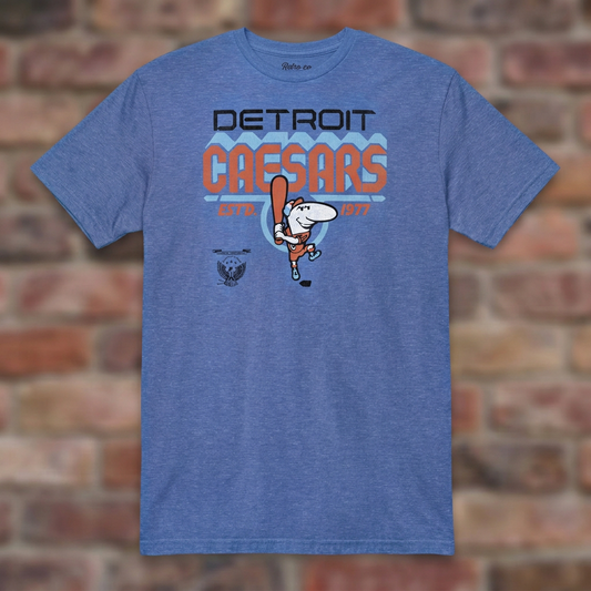 Detroit Caesars Heather Royal T-shirt flat lay on brick background