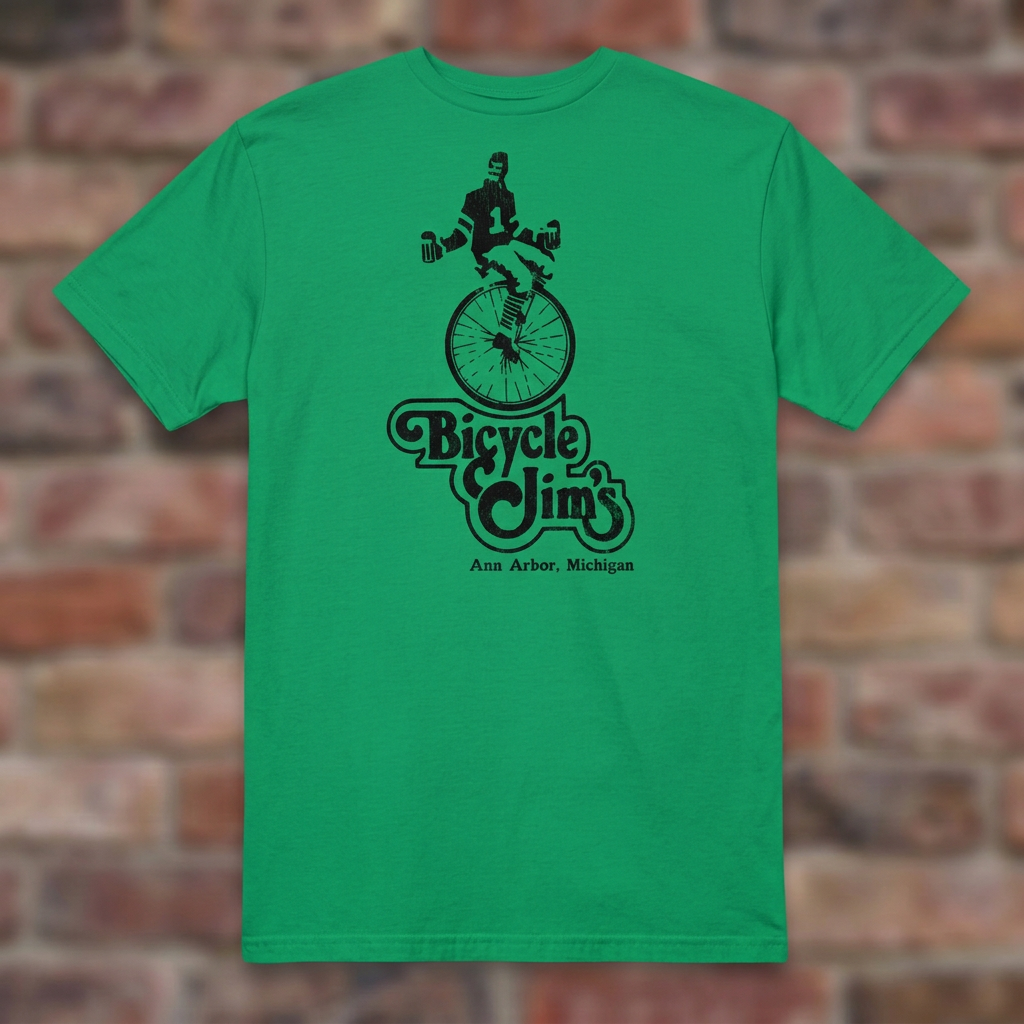 Bicycle Jim's Irish Green T-shirt flat lay on brick background
