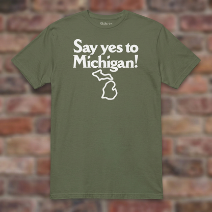 Say yes to Michigan Military Green T-shirt flat lay on brick background