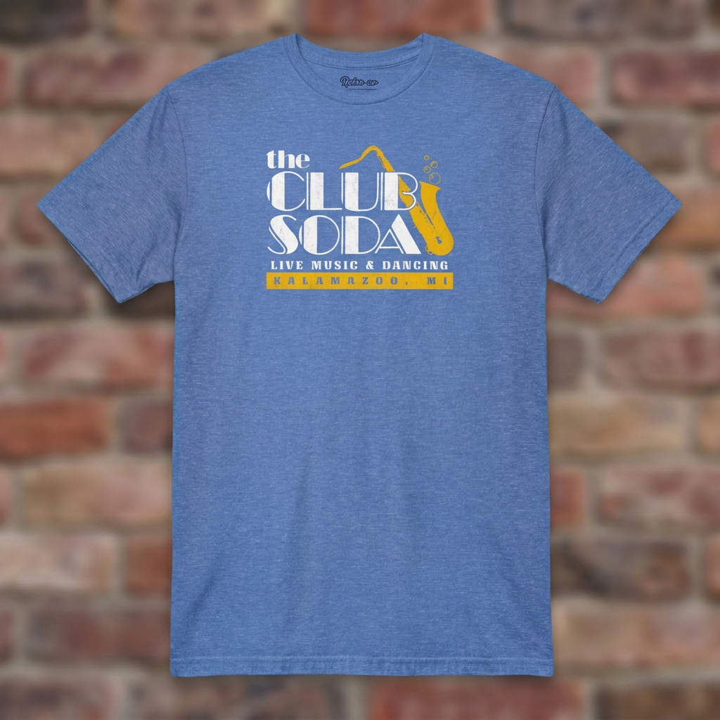 The Club Soda Kalamazoo T-shirt in Heather Royal on a weathered brick background