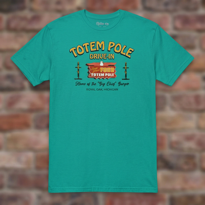 Totem Pole Drive-In Jade Dome T-shirt flat lay on brick background