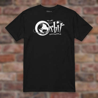 The Orbit Room Black T-shirt flat lay on weathered brick background