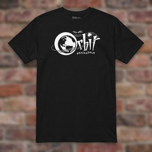 The Orbit Room Black T-shirt flat lay on weathered brick background